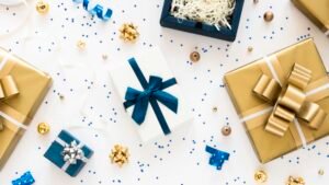 Gift boxes with ribbons and confetti on white background.