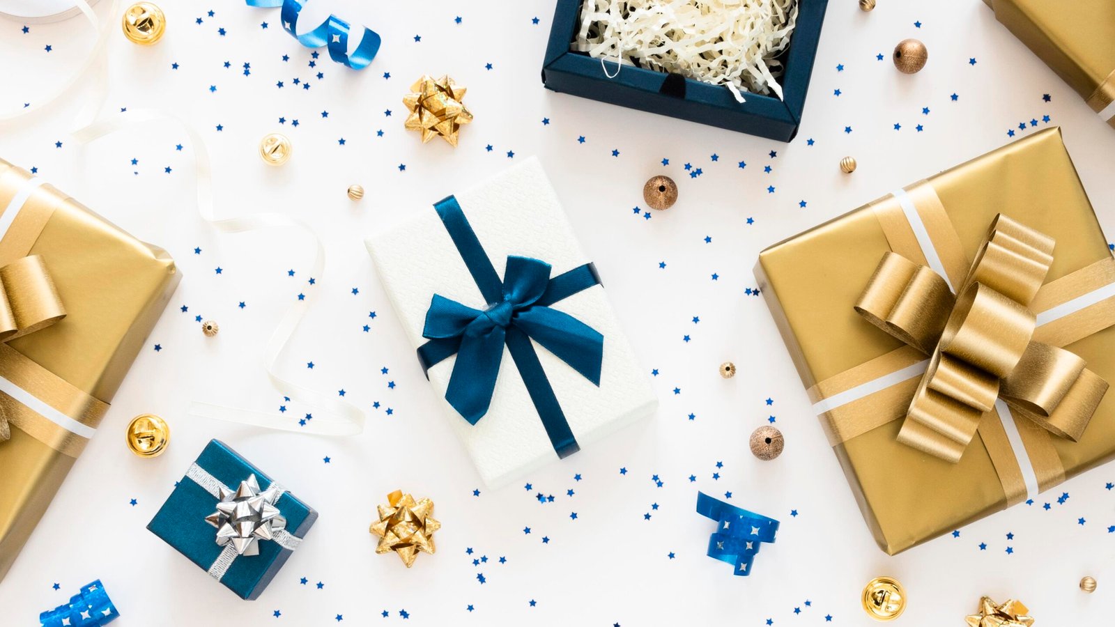 Gift boxes with ribbons and confetti on white background.